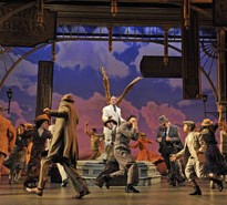 Stef Tovar as Harold Hill and the cast of The Music Man dance around the Paramount stage