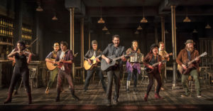 Guy (Barry DeBois, center with black guitar) and the ensemble in Paramount Theatre's Once. Photo credit: Liz Lauren